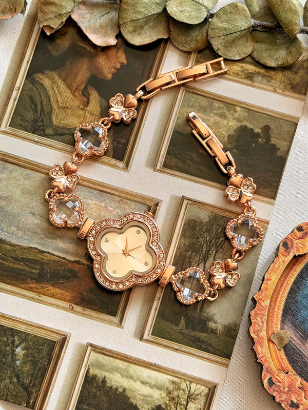 Şeffaf taşlı yonca ve kelebek detaylı rose gold kadın saatin açık kordonla tam görünümü